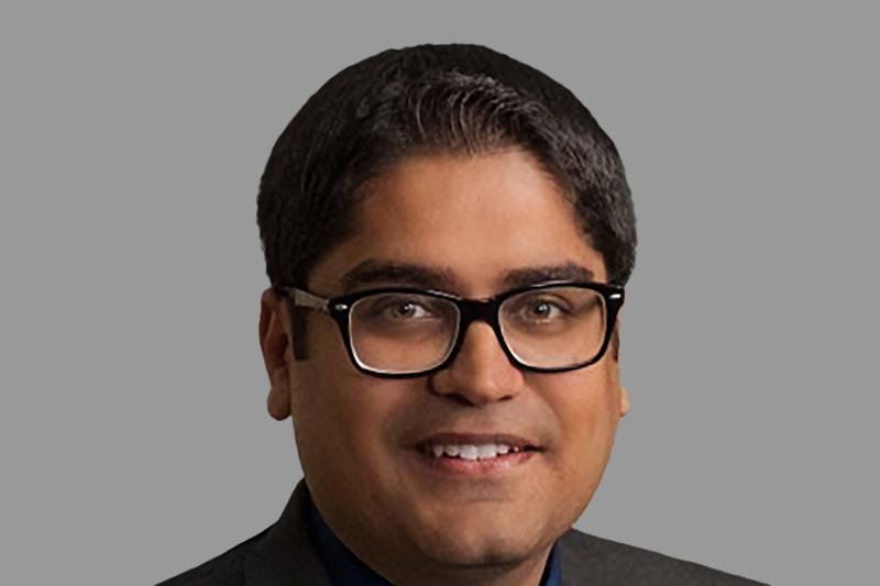 A close-up headshot of Shashank Pasrija in front of a light gray background.