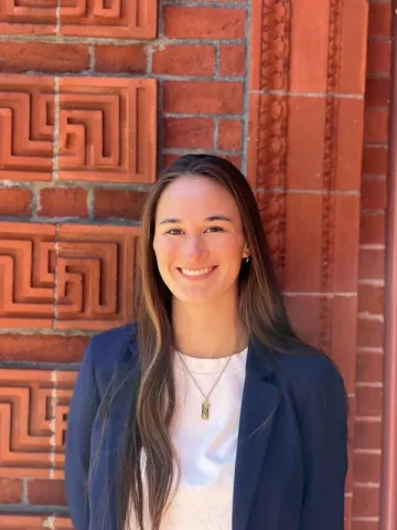 Carina Richeson smiles for a picture outside of a building on Fletcher's campus.