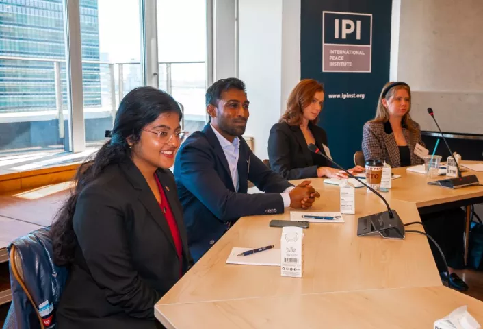 People speaking at a conference table