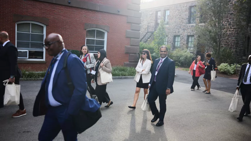 A group of participants walking on the Tufts University campus as part of the Global Diplomacy Institute, a leadership development program for mid-career and senior diplomats offered by Fletcher Executive Education 