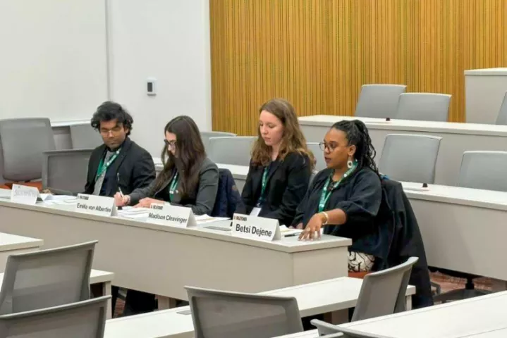 Fletcher students sit at a row of desks and speak.
