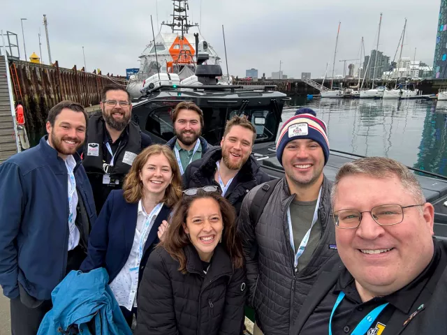The Fletcher delegation to the Arctic Circle Assembly smiles for a selfie at a marina.