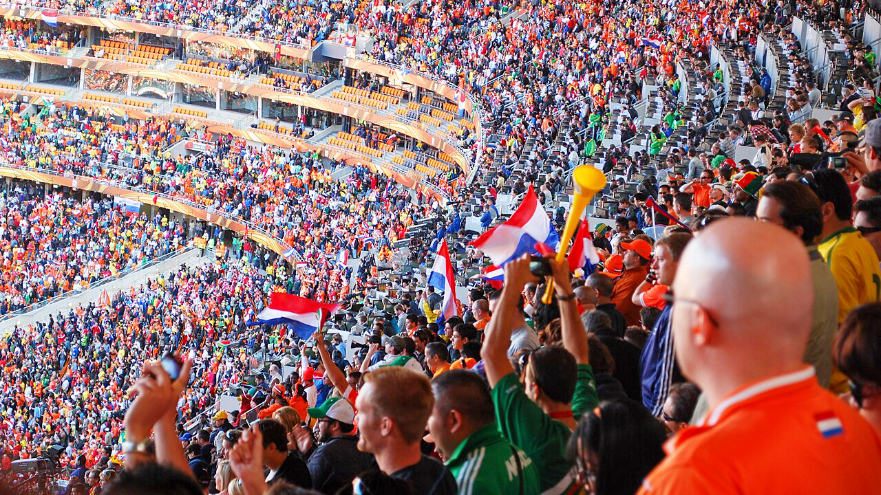 Dutch and Danish fans cheer during the Netherlands vs. Denmark World Cup soccer match at Soccer City Stadium in Johannesburg, South Africa, on June 14, 2010
