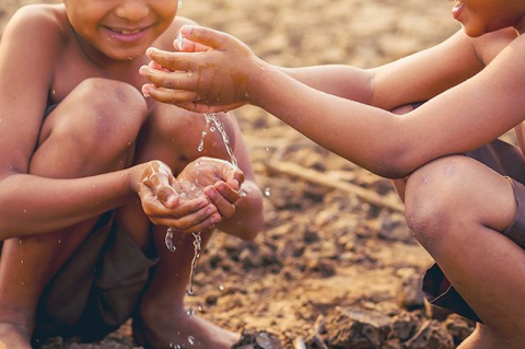 Two kids playing with water 