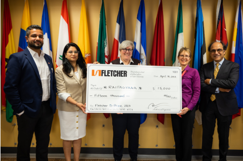 A group of people holds the prize check for the 2023 Fletcher D-Prize