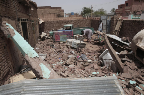 A man cleans debris of a house hit by a bomb in recent fighting in Khartoum, Sudan. A Tufts expert explains what’s behind the fighting in Sudan, where the Sudanese army and its main militia rival are turning the country into a battle zone.