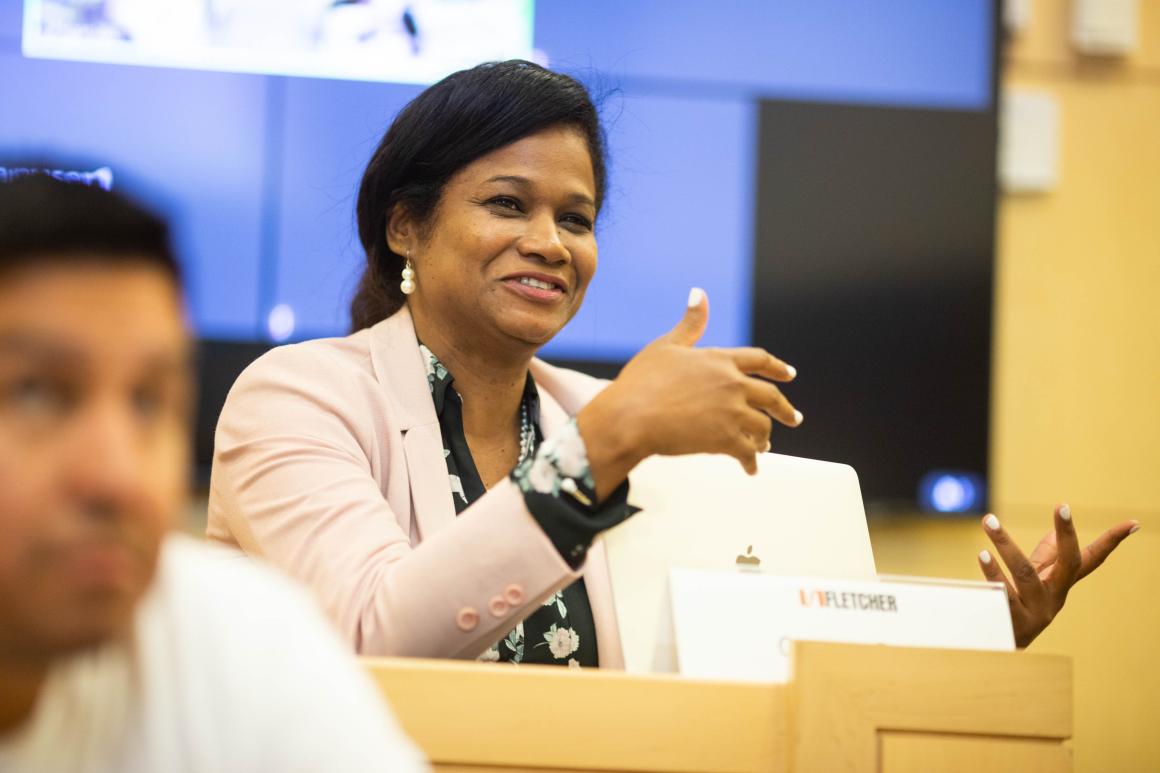 Person sitting and speaking with hand gestures