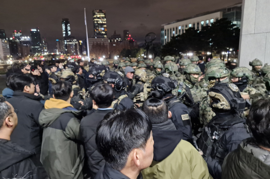 A crowd of people and soldiers in South Korea