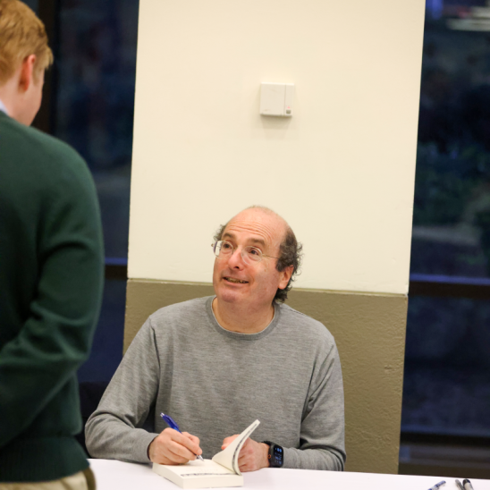 David Grann signs a book for an event attendee. 