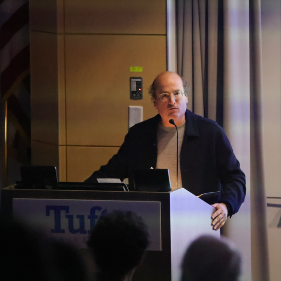 David Grann stands at a podium delivering a speech.