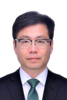A headshot of Yeo Han-Koo in front of a white background