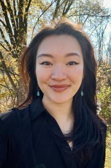 A headshot of Serena Chow in front of trees outdoors.