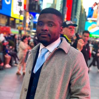 Edward Okyere-Darko poses for a picture in a busy city.
