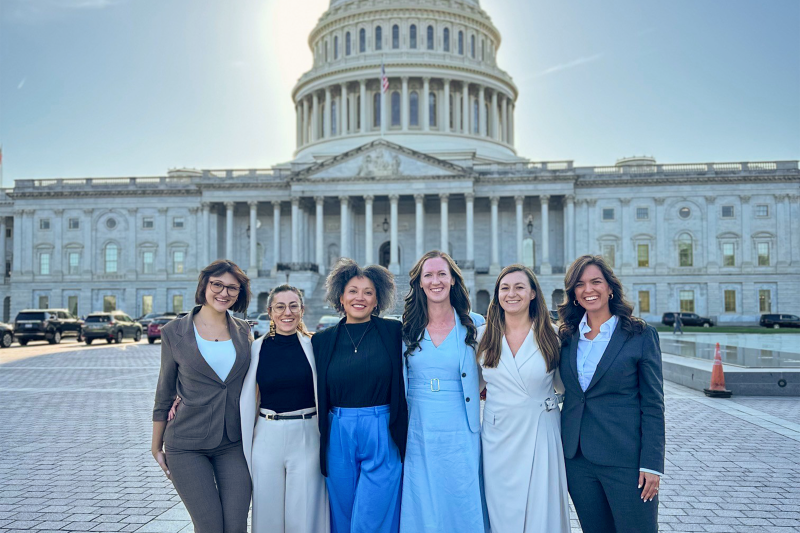 Meredith Lipnick poses for a picture with five other people in front of the United States Capitol.