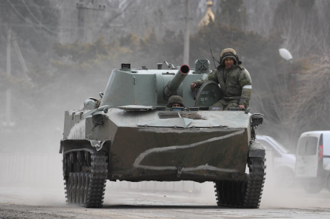A Russian tank with a soldier on top on a road in Crimea. Tufts experts talk about what’s behind Russia’s invasion of Ukraine, and what can be done about it